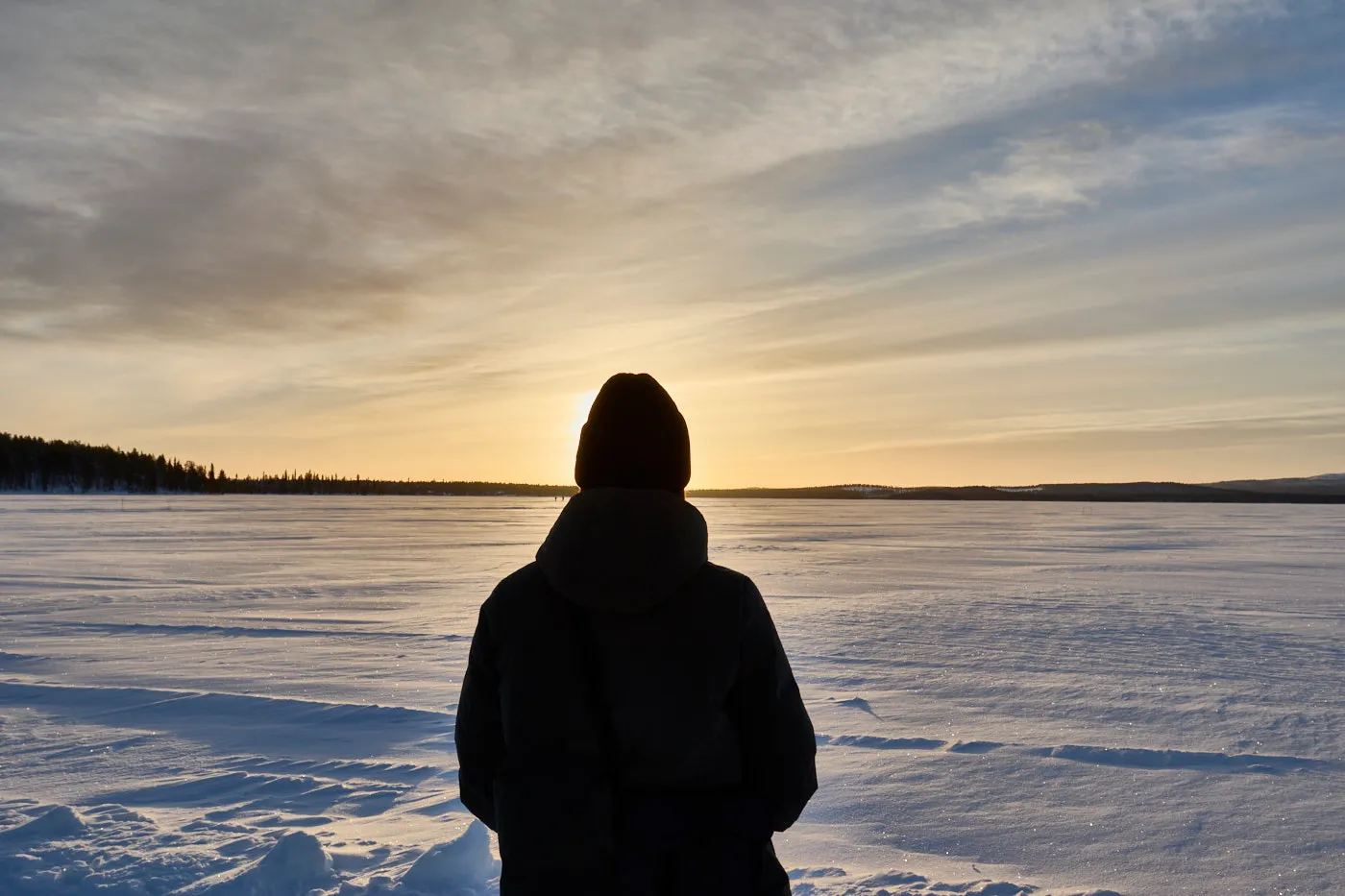 Watching sunset frozen lake lapland